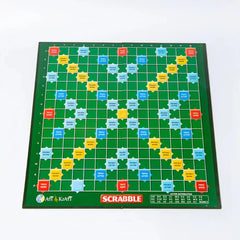 A classic Scrabble board game with tiles arranged for gameplay, including a green game board, wooden letter tiles, and score keeping materials.
