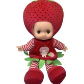 A doll designed to look like a strawberry, with a red body, green accents, and a striped outfit.