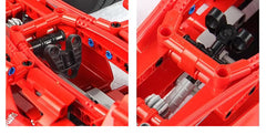 Close-up of a red mechanical model with intricate details on a black background