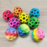 Colorful polka dot balls on a wooden surface