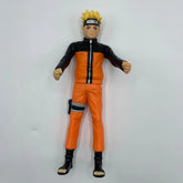 Action figure in orange and black outfit on a white background