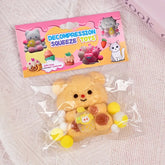 Packaged decompression squeeze toy with a pink packaging label on a textured surface