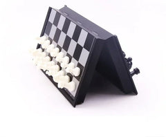 Folding chess set with pieces on a white background