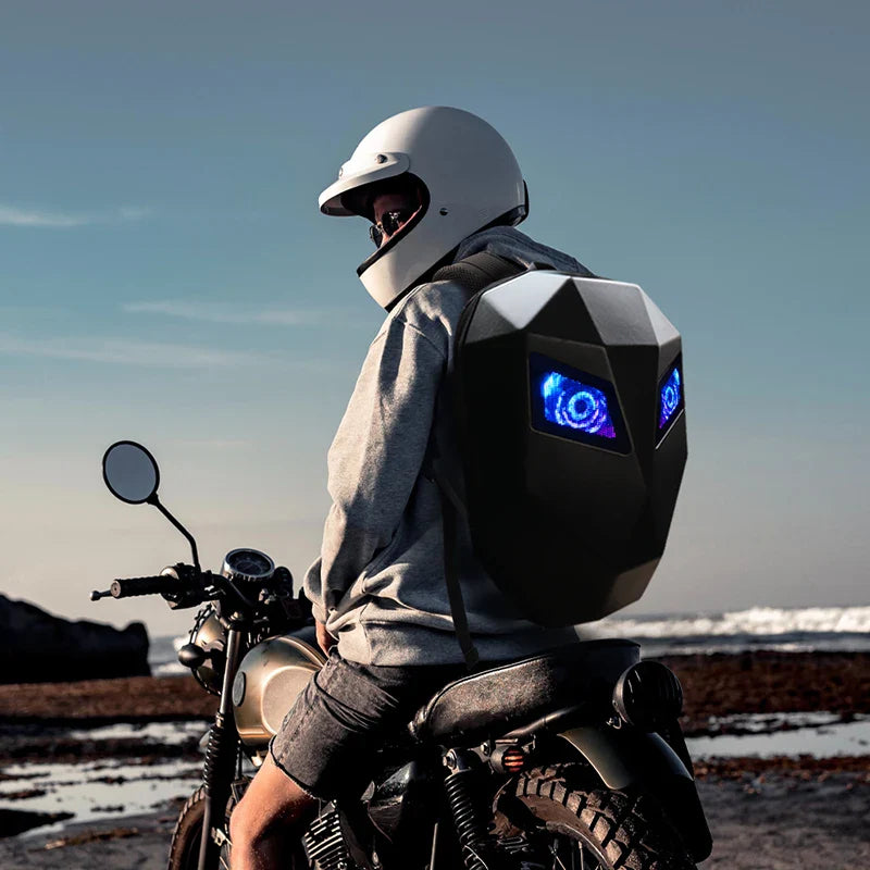 Person on a motorcycle wearing a futuristic backpack with glowing blue elements.