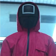 Person wearing a red raincoat and  Squid Game Square Guard Mask