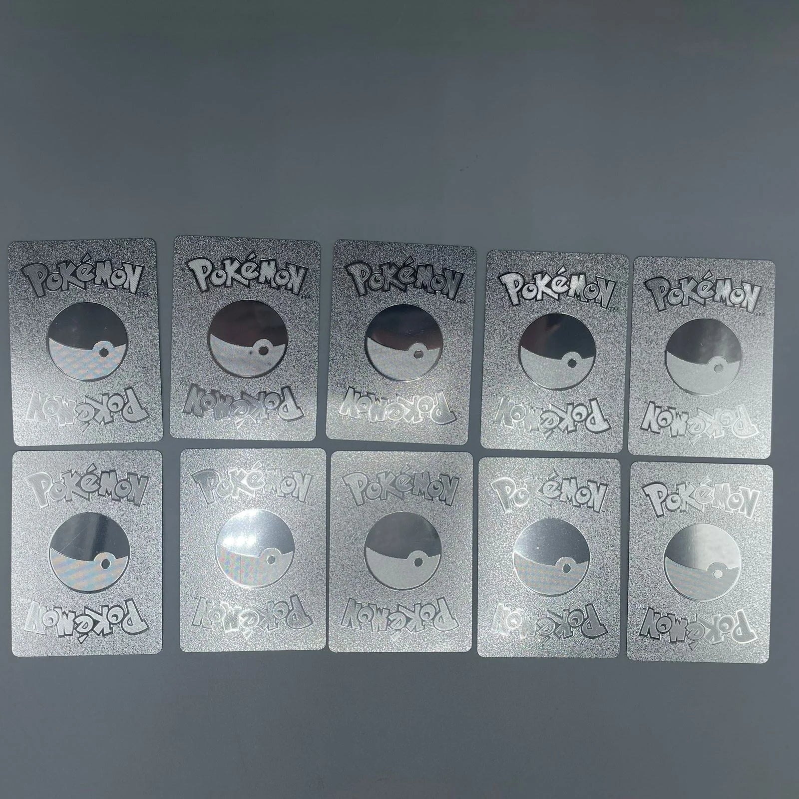 Pokémon cards arranged in a grid on a gray background