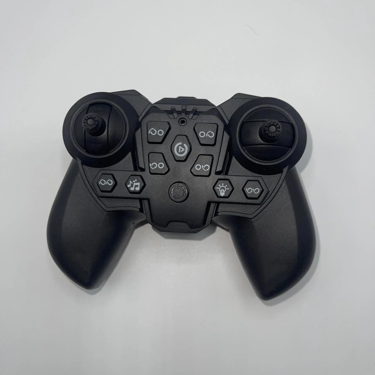 Black gaming controller on a light gray background