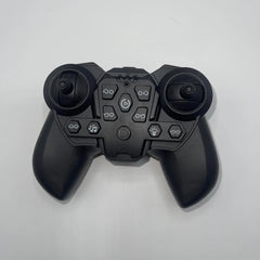 Black gaming controller on a light gray background