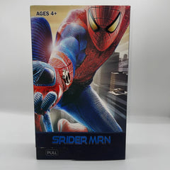 Spider-Man toy figure packaging with cityscape background