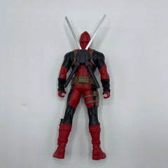 Action figure in red and black costume with a sword on a white background
