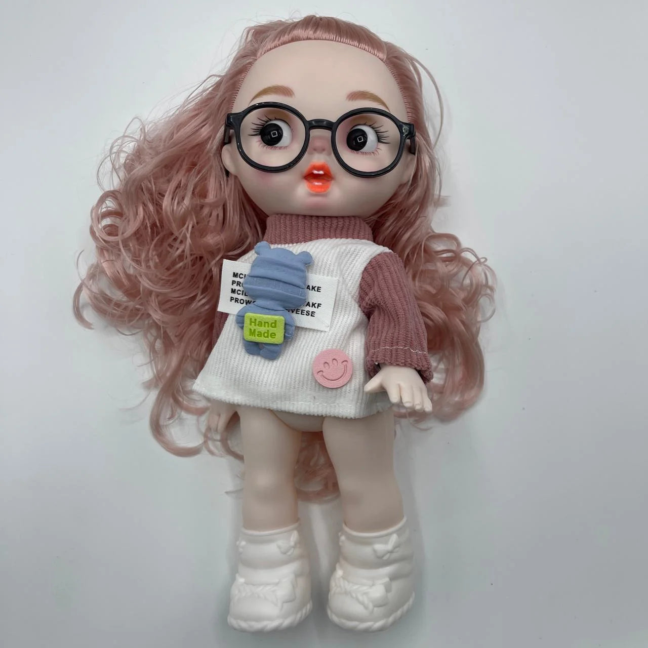 Doll with pink hair, glasses, and a white dress on a light gray background
