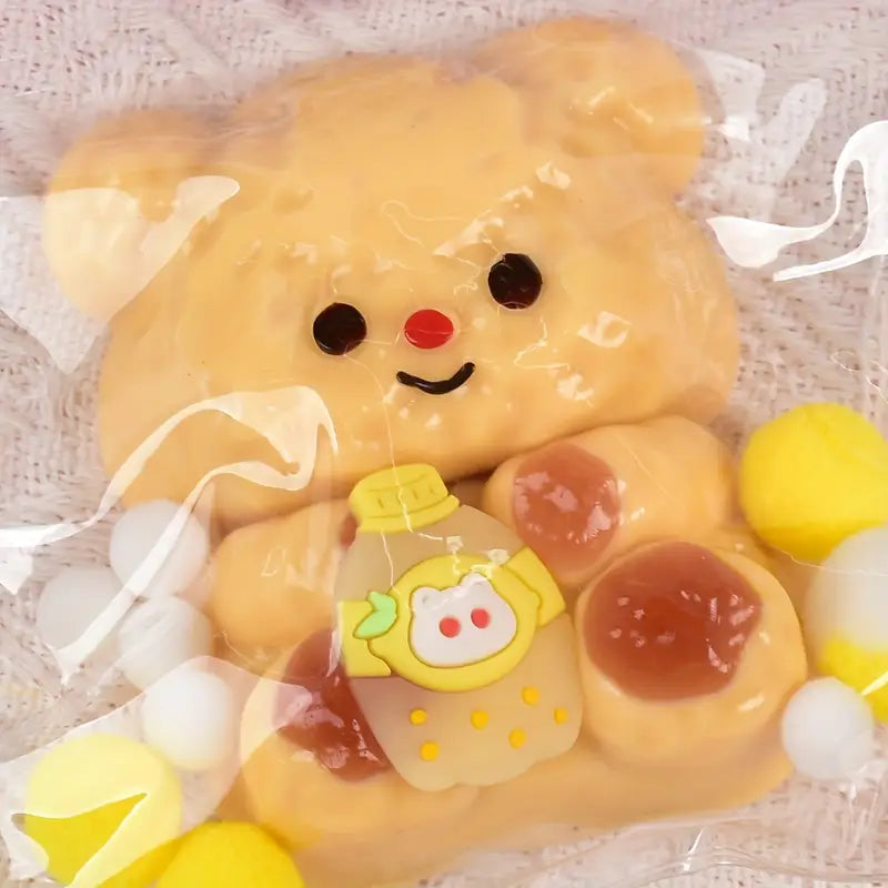 Yellow bear plush toy with a bottle of honey on a light background