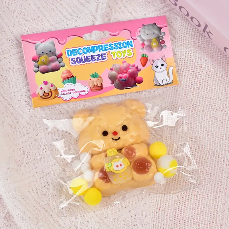 Packaged decompression squeeze toy with a pink packaging label on a textured surface