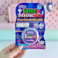 Packaging of Wire Drawing Mud with a hand holding it against a blurred background